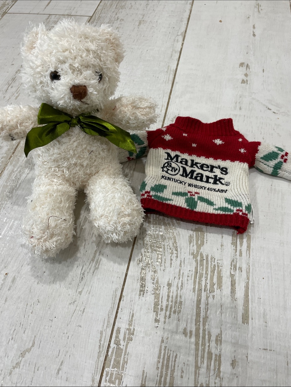 Makers mark bottle sweater with a Cody bear stuffed animal